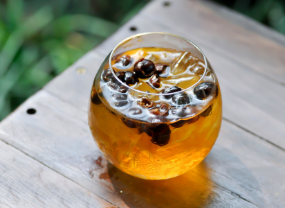 a delicate round glass full of cascara brew tea